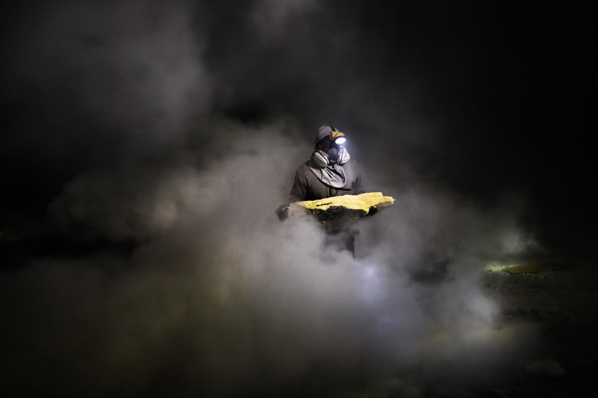 LPAN, 27 years old, a sulfur miner for ten years now, looks for sulfur slabs under the toxic fumes. Indonesia 2014